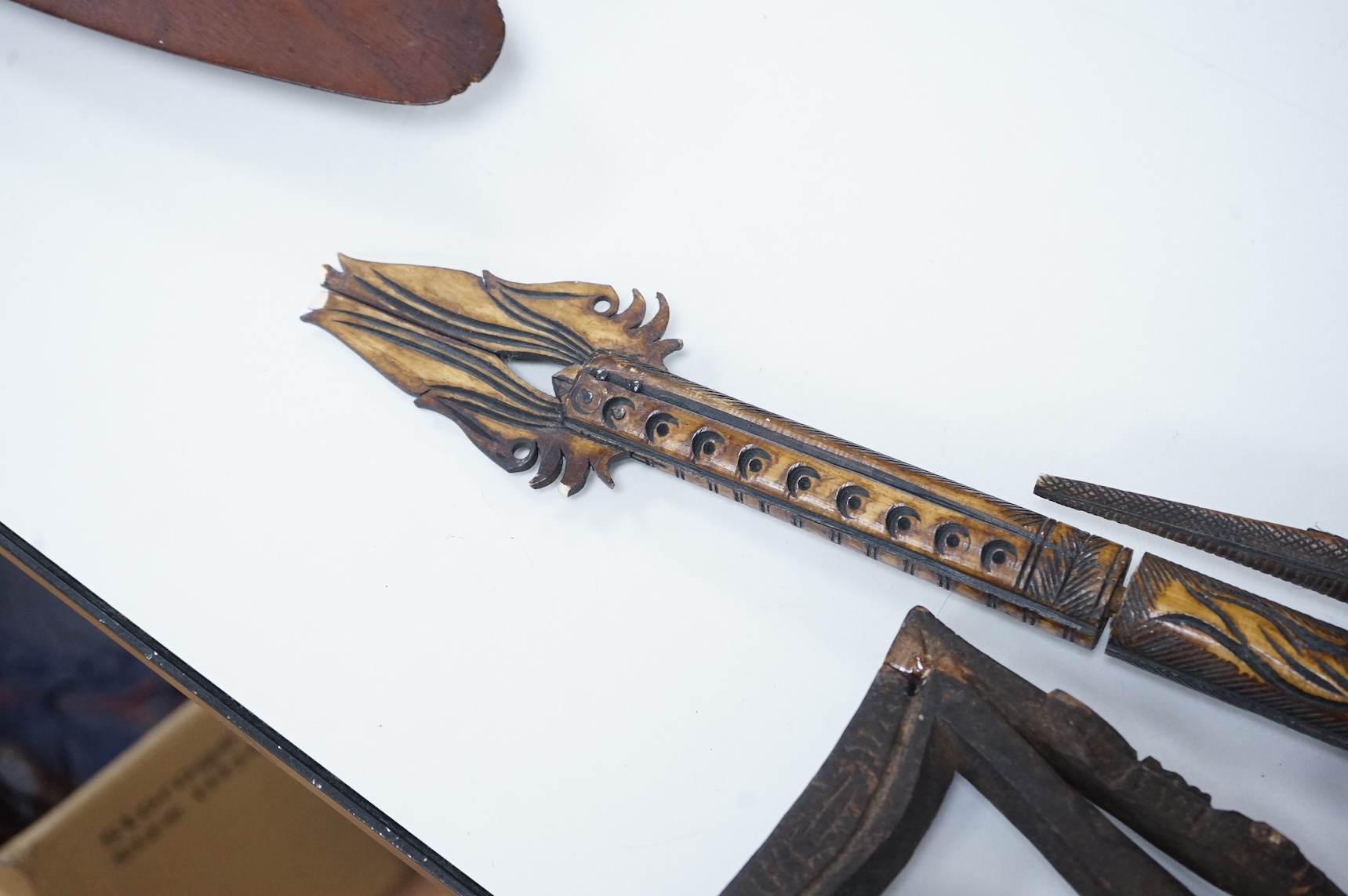 Two Papua New Guinea Sepik River carvings and a carved bone artefact, largest 92cm in length